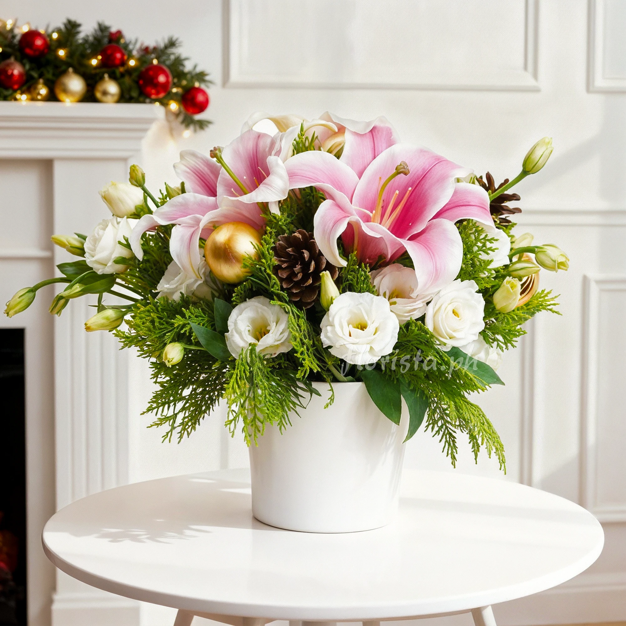 An arrangement of 2 pink lilies, 10 white roses, 2 pinecones and golden balls with green fillers in a white round box.